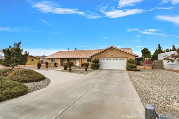 Long driveway with circular drive, twin rolling gates at either end of the circular. All the gravel beside the driveway is perfect for storing and serves as a driving surface leading to the double gates beside the house.