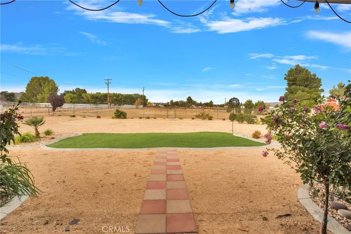 Easy care with turf, curbing, granite gravel, and desert hardy plants.