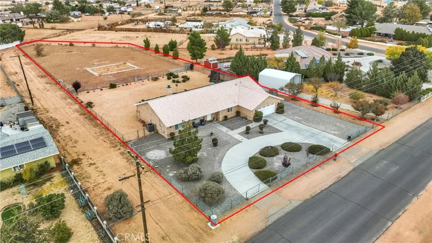 Great separation from adjoining properties. Note that the house next door faces the other street, and this utility access provides separation between this next door neighbor. Double drive through gates to the rear portion of the property.