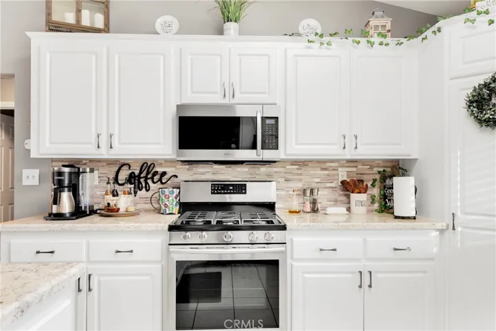 Remodeled kitchen with granite counters with beveled edge. Door pull hardware matches the high end appliances. Corner pantry.