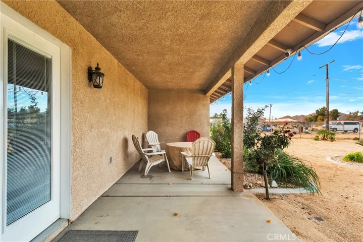 Large rear covered patio overlooking the private back yard.