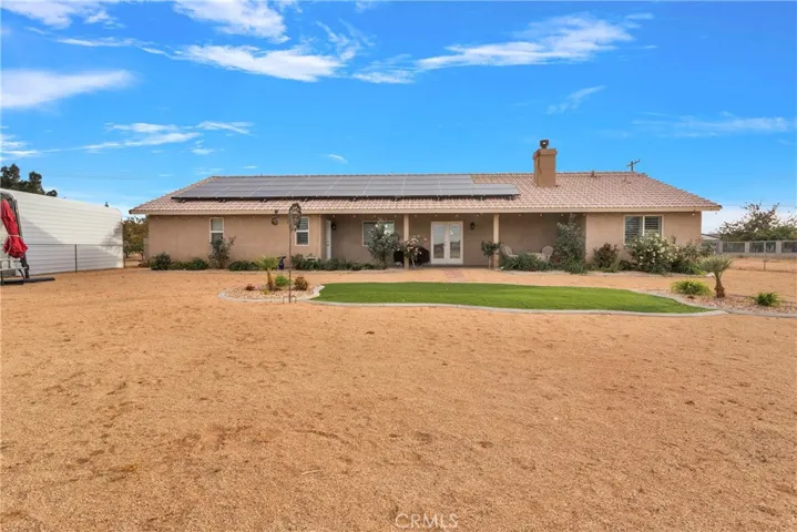 Granite gravel, turf, curbing, and desert hardy plants in this portion of the back yard.
