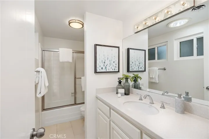 Hallway bath with shower in tub.