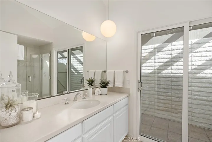 Primary master bath (en suite) looks out to a private atrium where there's also a separate entry.