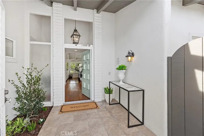 As you enter the front courtyard, the private atrium and additional entry are on the right.