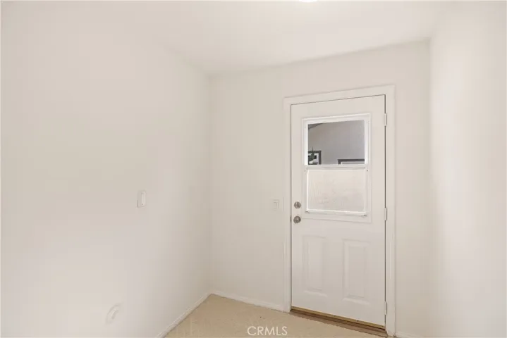Bonus/utility room, unstaged. Use as an office, craft room, mudroom, etc., or you can return the washer/dryer from garage back into the home.