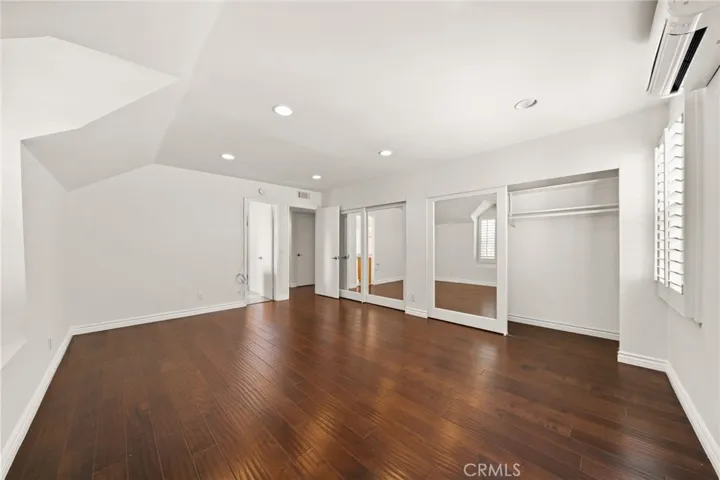Primary Bedroom with mirrored closet doors
