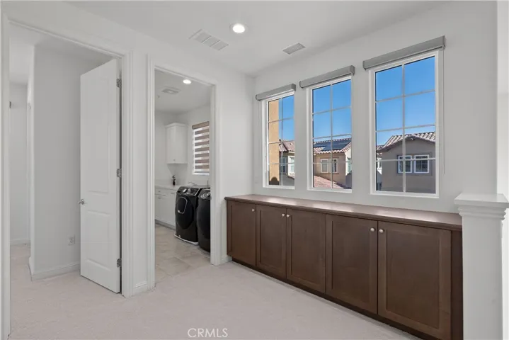 Custom Cabinetry Ups stairs into Laundry room