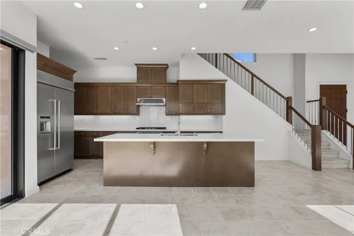 Kitchen with Built in Fridge and stainless steel appliances