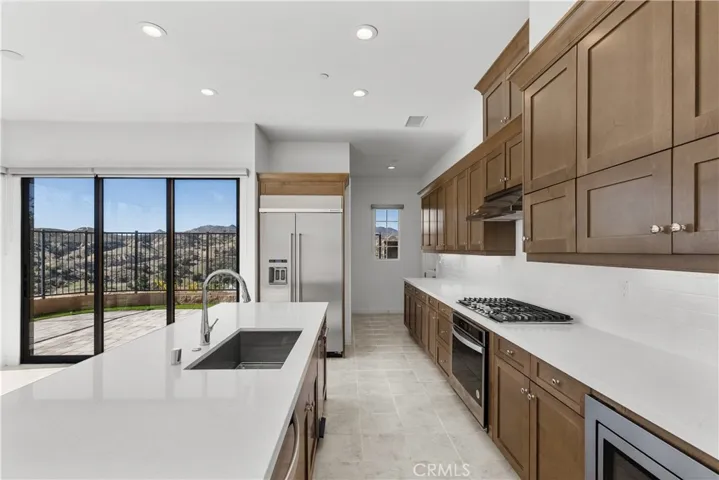 Kitchen with Built in Fridge and stainless steel appliances, Built in Microwave, Built in Compacter etc.