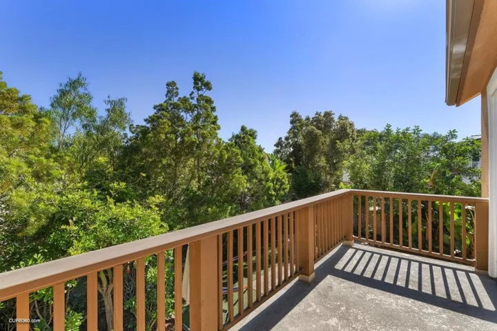 Balcony off Primary Bedroom overlooking tropical rear yard