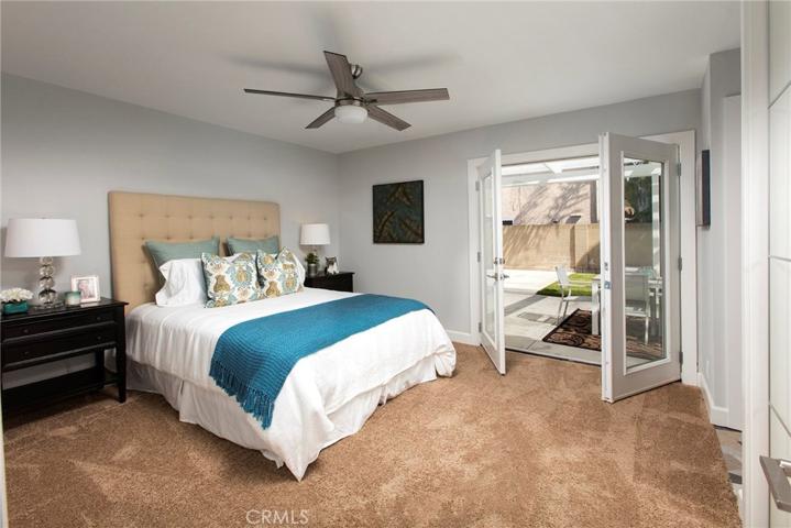 Master bedroom with beautiful doors leading to the back yard