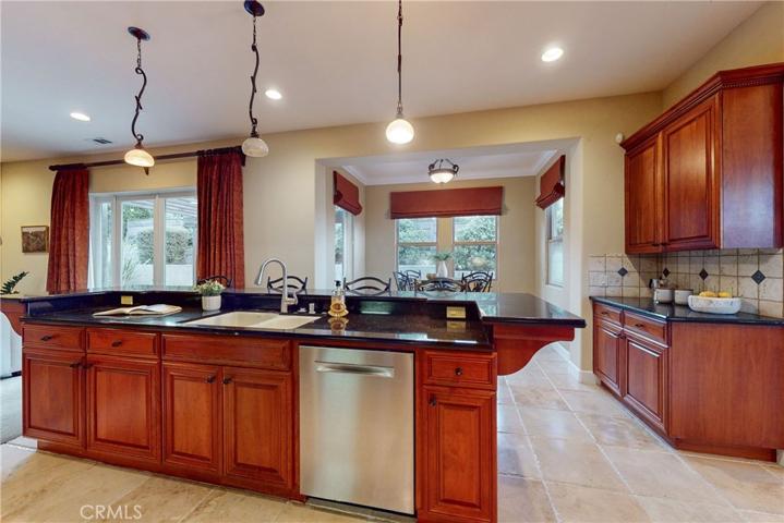 Center island with double sink and breakfast bar