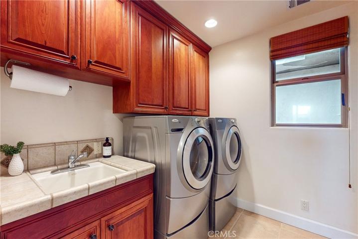 Laundry Room with Sink, Counter Space and Cabinetry