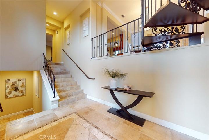 Inviting Entry Foyer with Travertine Tile Floors and Soaring Ceilings