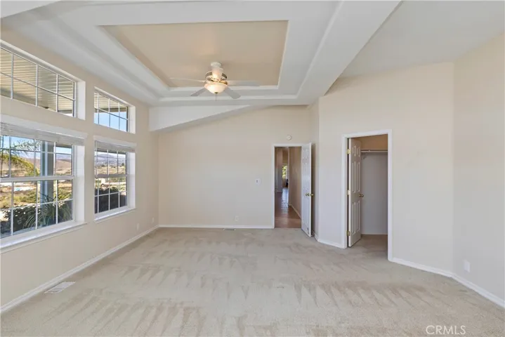 MAIN HOUSE PRIMARY BEDROOM HAS DOUBLE FRENCH DOORS TO PRIVATE COVERED PATIO