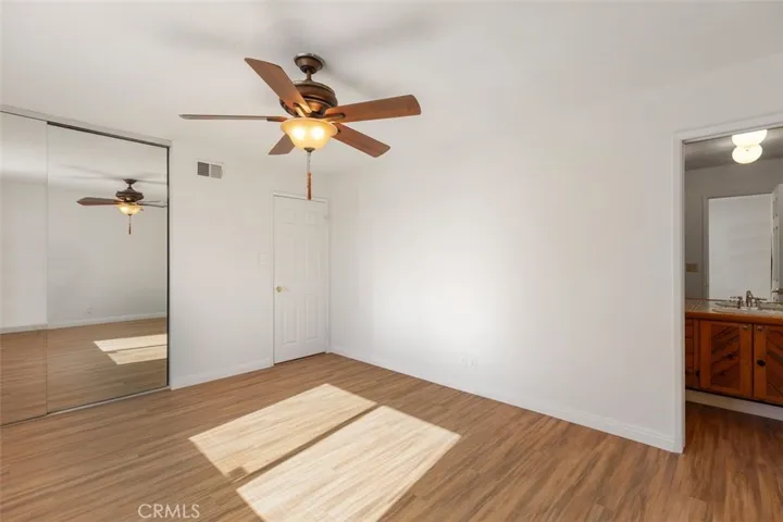 Primary Bedroom with mirrored closet doors.