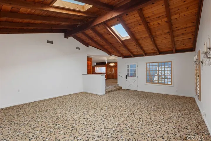 High Beamed ceilings with a step of from the Living room.