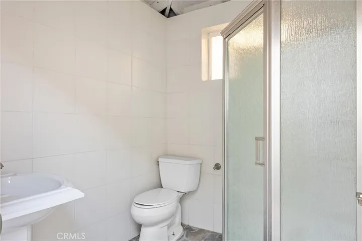 Outdoor bathroom with shower and changing room next to the pool