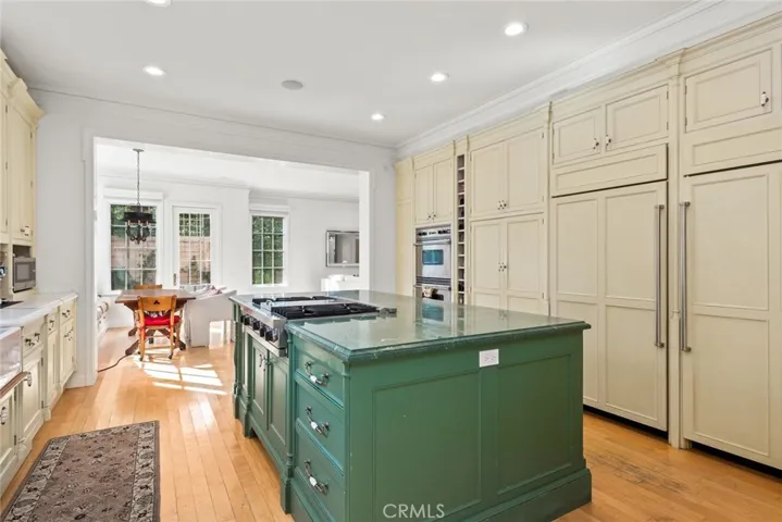 The kitchen island has cupboards and drawers on both sides.