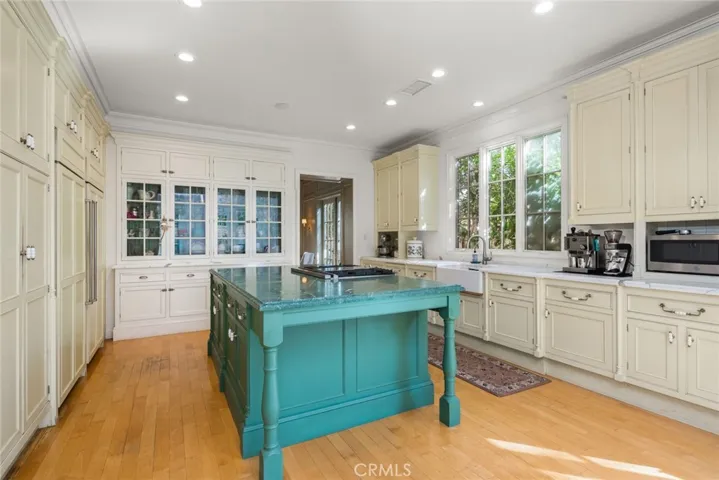 The island color is the watermelon green of previous photo. The Scullery Cabinet is at the far end painted white and is a beautiful display as well as lower cupboard space and drawers.