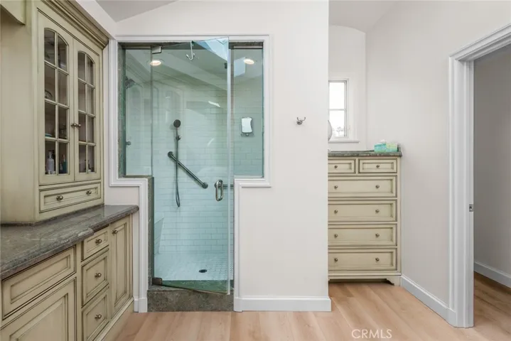 Choices galore in the Walk-in steam shower with shower heads as both ends, bench across left end, a hand held shower wand and ceiling shower heads.