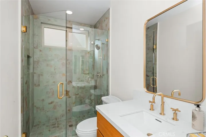 Newly remodeled main floor bath with step in shower, floating riff sawn white oak vanity with self closing drawers.(color is off in photo more a beige tone).