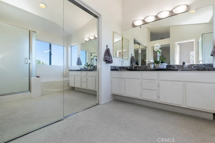 Mirrored walk in closet.