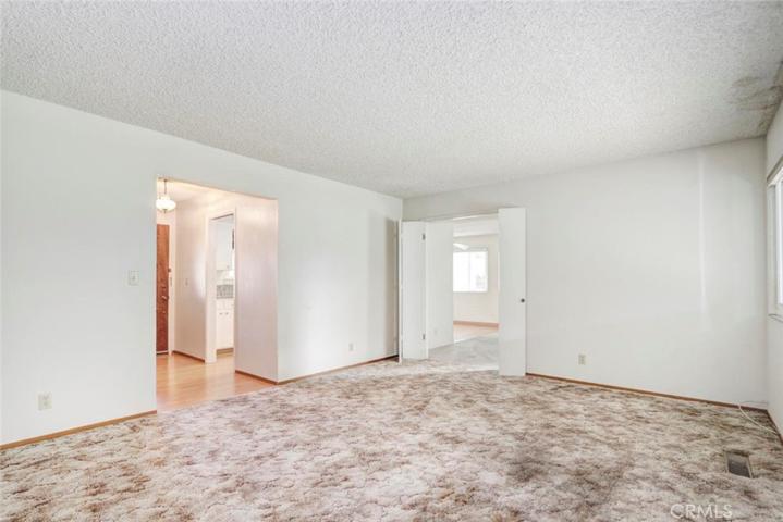 Living room with double doors opening to the family room.