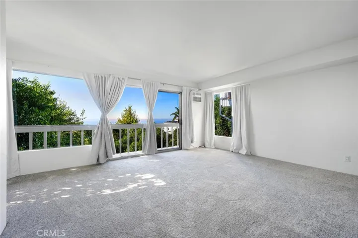Primary bedroom with ocean views and a new deck to enjoy.