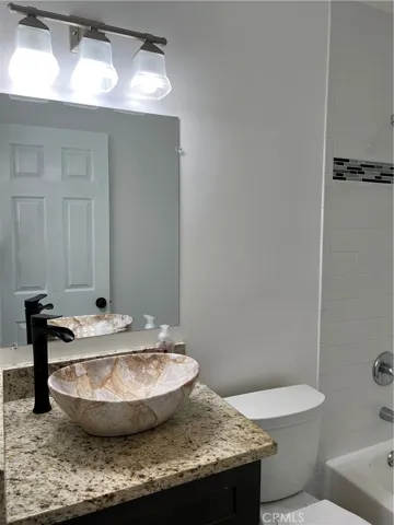 Hall/guest bathroom tastefully renovated with modern fixtures