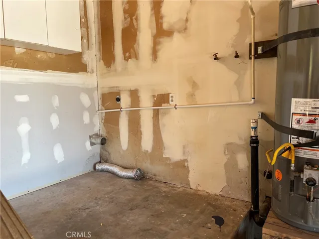 Laundry area located in garage