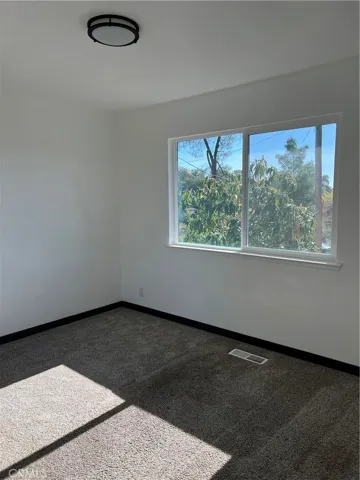 bedroom 2 features mirrored closet doors and carpet