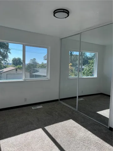 bedroom 3 also features mirrored closet doors and carpet