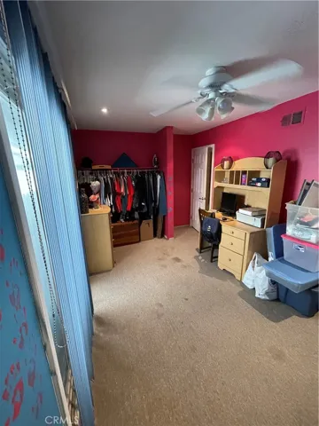 Bedroom #3 with ceiling fan and a sliding door to the side yard