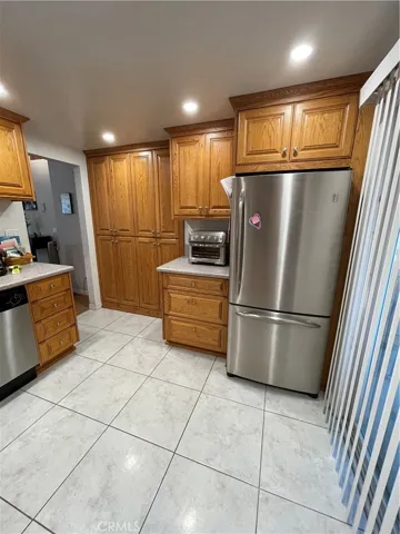 To the right is a slide-door going to the patio. The stainless steel refrigerator stays! But WAIT, there's more!