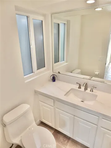 Powder room downstairs with new comfort level toilet &  Quartz counter top
