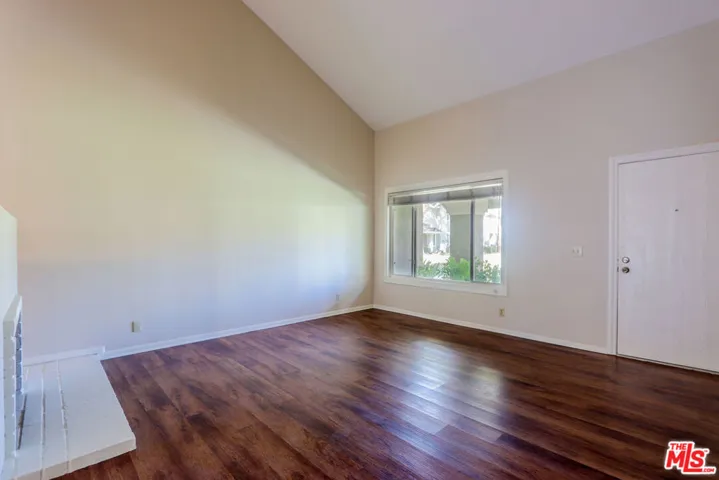 Living Room with Vaulted Ceiling and Fireplace