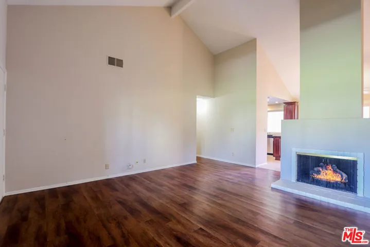 Living Room with Vaulted Ceiling and Fireplace