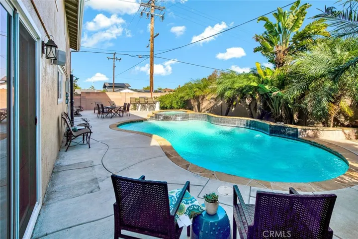 Tropical Oasis Resort-Style Backyard with Pool/Spa, Shower, Slate BBQ Center wit Seating, and Lots of Deck Area that's Perfect for all your Entertaiing Dreams!