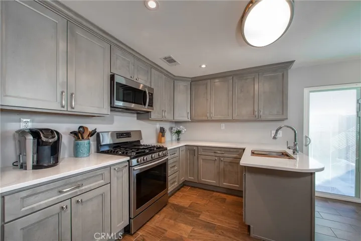 The recently updated kitchen has beautiful gray shaker cabinets with soft close doors and drawers.