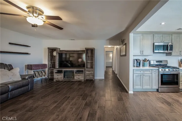 Stepping into the large living room you are greeted with wood-like tile flooring that is throughout most of the home.