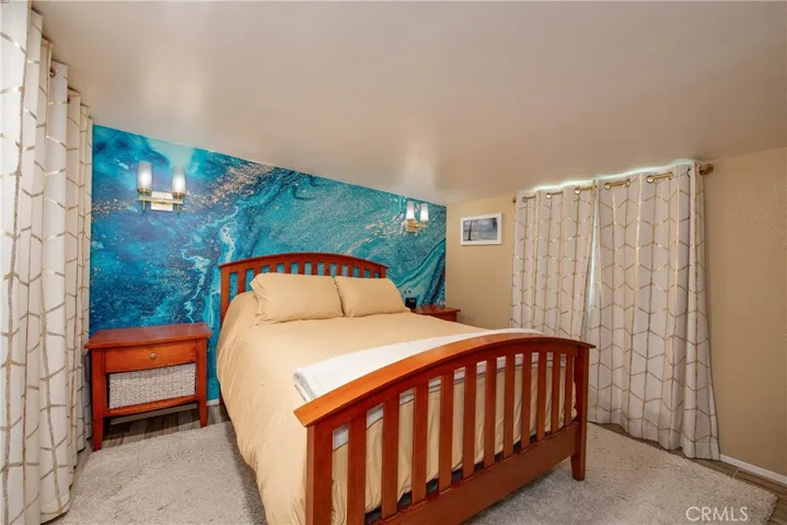 The primary bedroom is in the back of the home and has built-in shelving to the left.