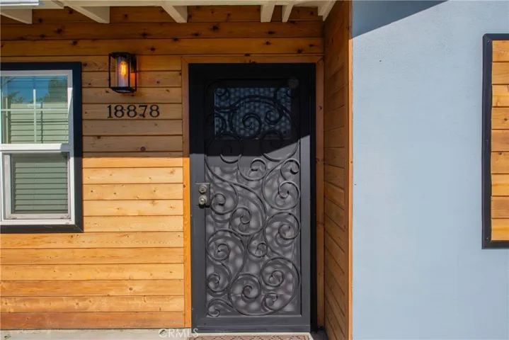 Enter through the decorative custom screen door.