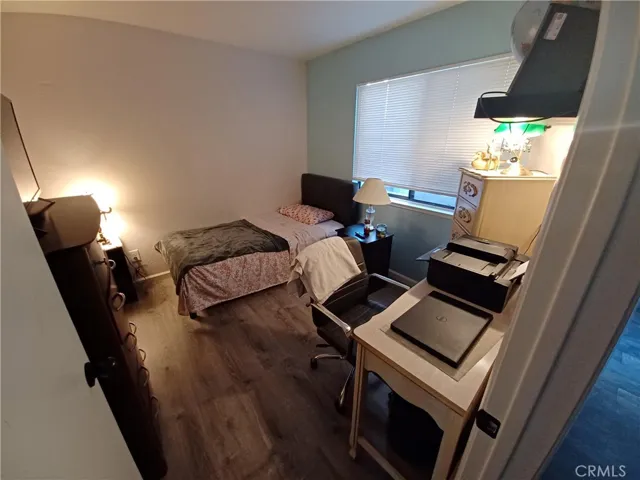 3rd bedroom w/ vinyl plank flooring. Window into private patio area.