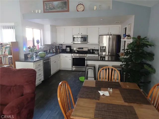 Beautifually upgraded kitchen with granite counters, recessed LED lighting, painted cabinets with handles. Stainless self cleaning stove w/ sealed burners, microwave, dishwasher,, Cabinet with 3 bar stools is moveable.