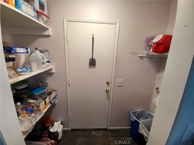 Pantry from kitchen with direct access to garage. Washer and dryer area to the right has been moved to the garage but still functional should you want them inside.