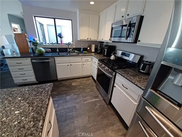 View from pantry. Lots of room for food prep, many drawers! Window into private patio area. One of the sellers is in the appliance business so they are NOT your basic model appliances. Note the extra drawer in the refrigerator!