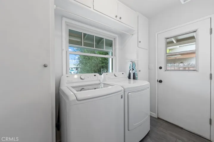Tucked away separate laundry room with storage galore