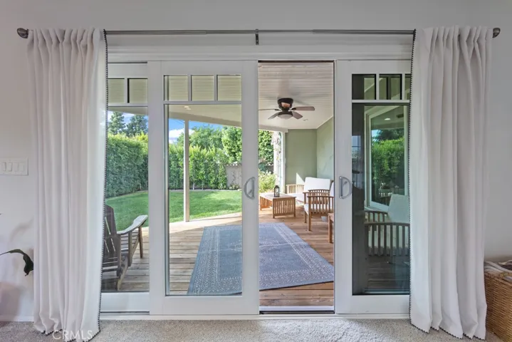 Gorgeous expanded dual pane slider grouping that showcases the backyard and deck